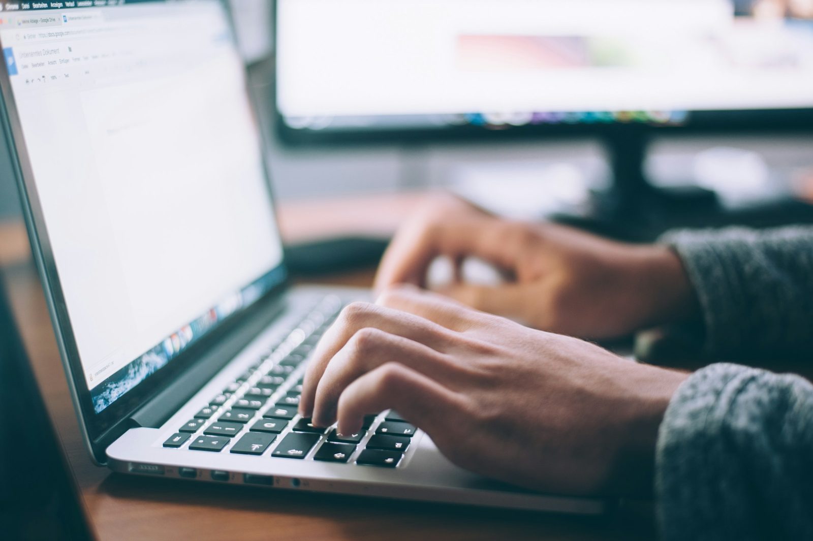 A professional working with an AI assistant on a laptop